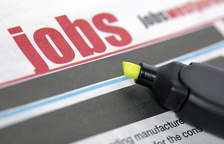 Job listing pages of a newspaper with highlighter pen