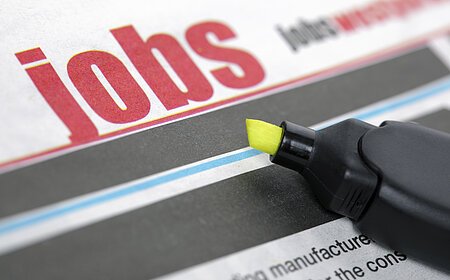 Job listing pages of a newspaper with highlighter pen