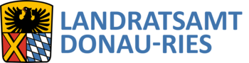 Wappen Landratsamt DONAU-RIES Wappen des Landratsamts DONAU-RIES: auf dem Wappen oben ein schwarzer Adler auf gelbem Hintergrund. darunter links ein gelbes Kreuz auf rotem Hintergrund und rechts davon bayerisches Rautenmuster in weiß-blau. Rechts neben dem Wappen der Text: Landratsamt Donau-Ries.